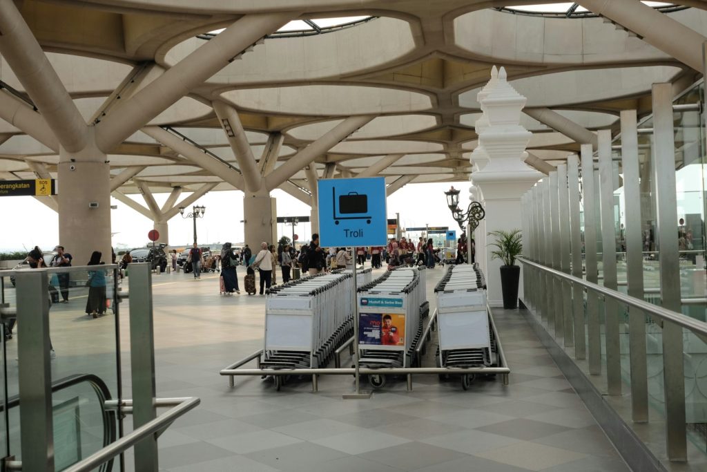 A group of luggage carts sitting inside of an airport